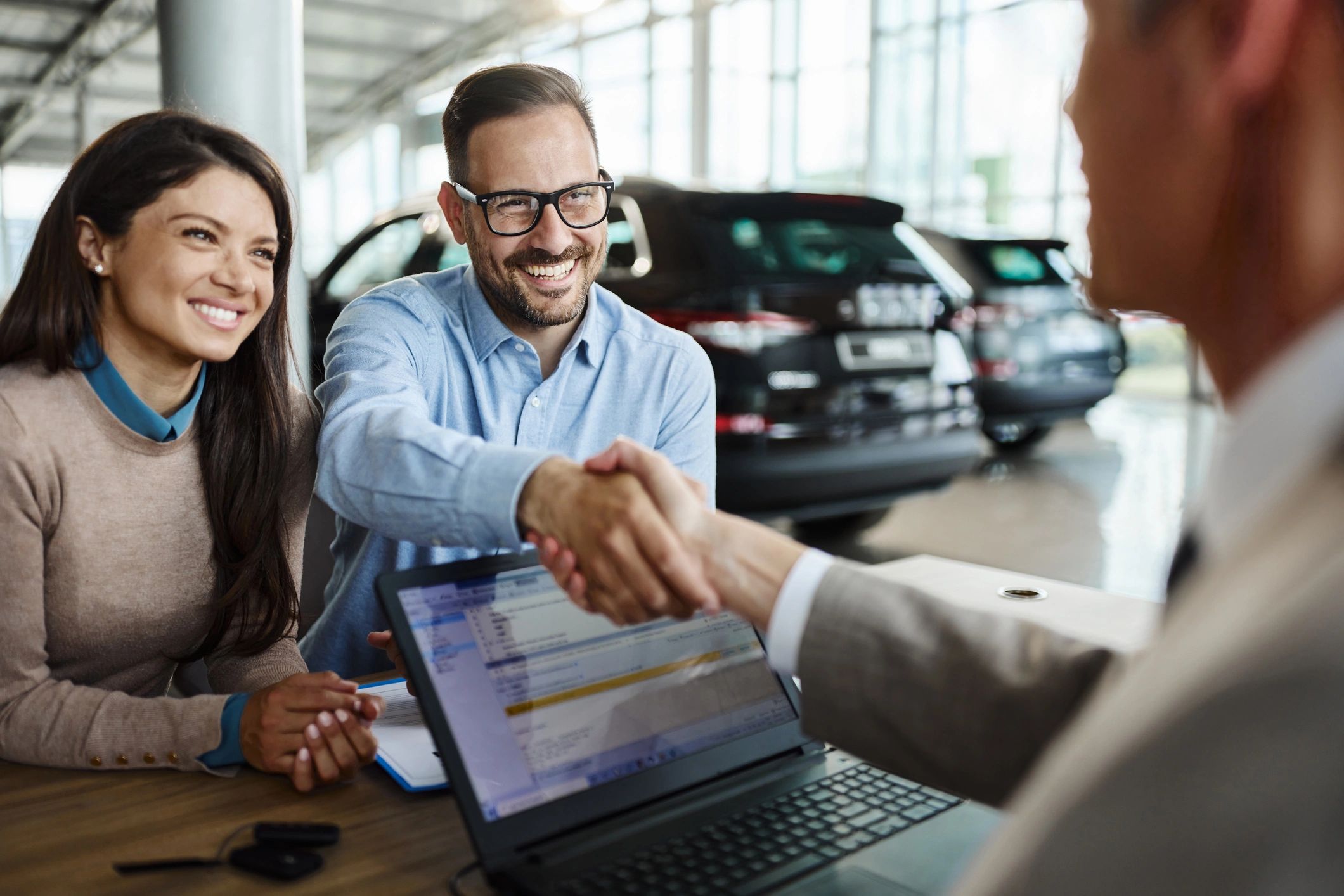 happy client handshake car dealership