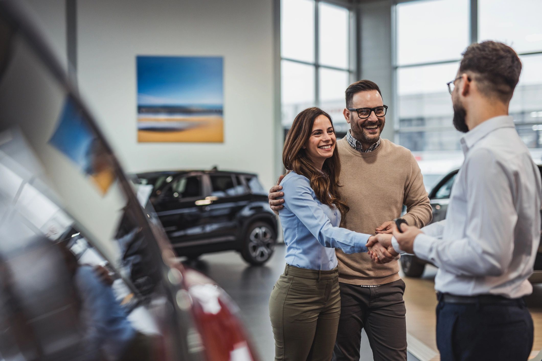 happy client handshake car dealership