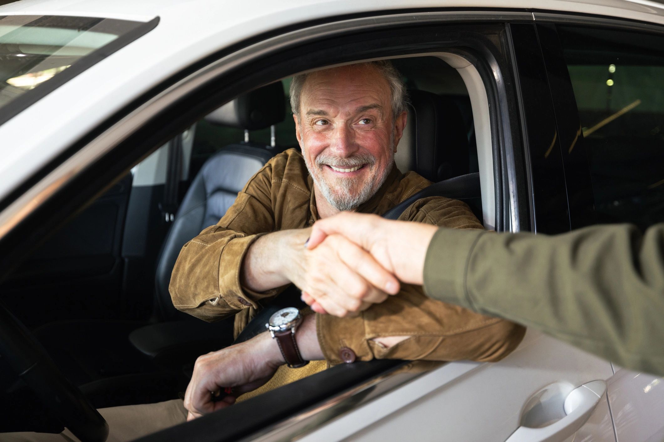 business handshake in car dealership